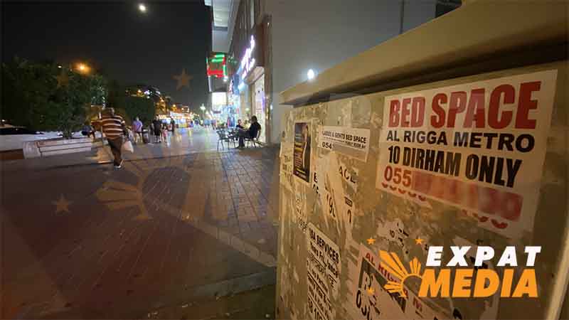 A poster of a bed space for rent in Dubai's Al Rigga area.
